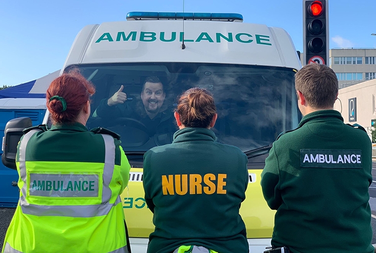 3 Uniforms in front of ambulance | AAMS Medical Personnel | AAMS